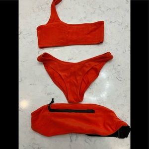 Triangl one shoulder bikini. Red. Shows signs of wear. Comes with bum bag.